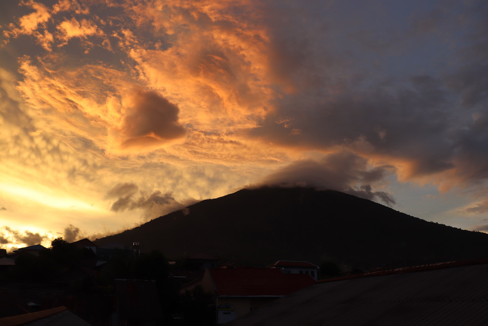 Gamalama volcano silhouette against a stunning sunset