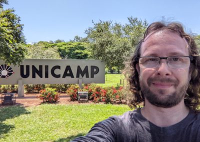 Lev in front of the UNICAMP sign for the University of Campinas in Brazil