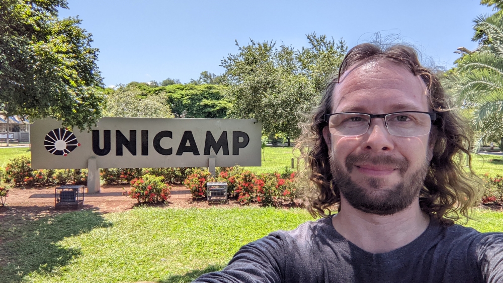 Lev in front of the UNICAMP sign for the University of Campinas in Brazil