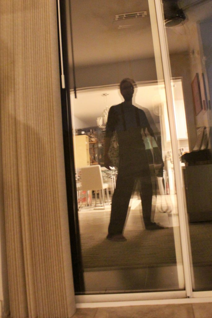 Silhouetted double reflection of a man with the two reflections overlapping offset